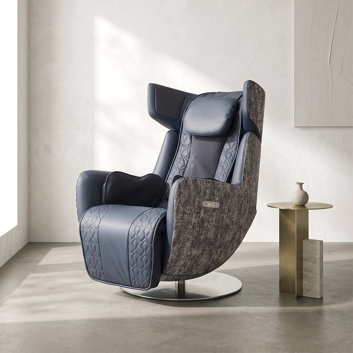 N-0005MB-V2, Midnight Blue ergonomic massage armchair in a bright, modern American living room during a sunny daylight saving time afternoon. The sophisticated navy blue leather and textured grey fabric lounger rests on a sleek concrete floor, featuring a circular metallic pedestal base. In the background, warm natural sunlight creates soft shadows on the white walls, illuminating a minimalist metallic gold side table with a ceramic vase and an abstract textured wall painting.
