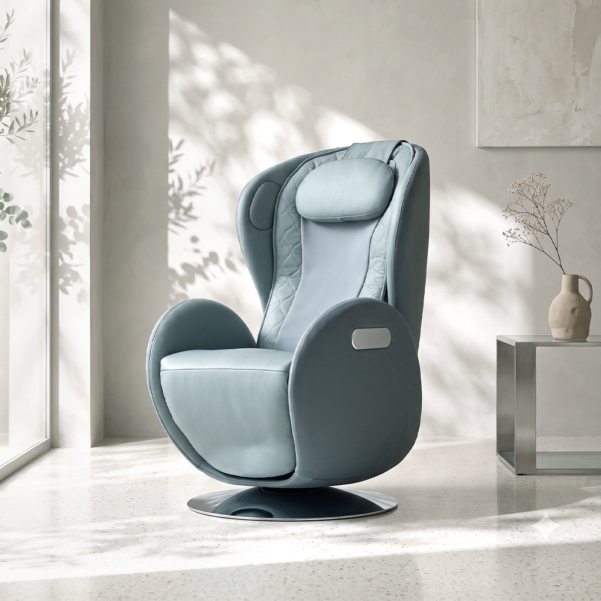 NR-SN100L-BU, Aqua Blue ergonomic massage armchair in a bright, modern American living room during a sunny daylight saving time afternoon. The elegant pastel blue leather and fabric lounger rests on a polished terrazzo floor, featuring a circular metallic pedestal base. In the background, warm natural sunlight streams through a large window, casting soft shadows of leaves on the white walls and illuminating a minimalist metallic side table with a ceramic vase of delicate dried flowers.