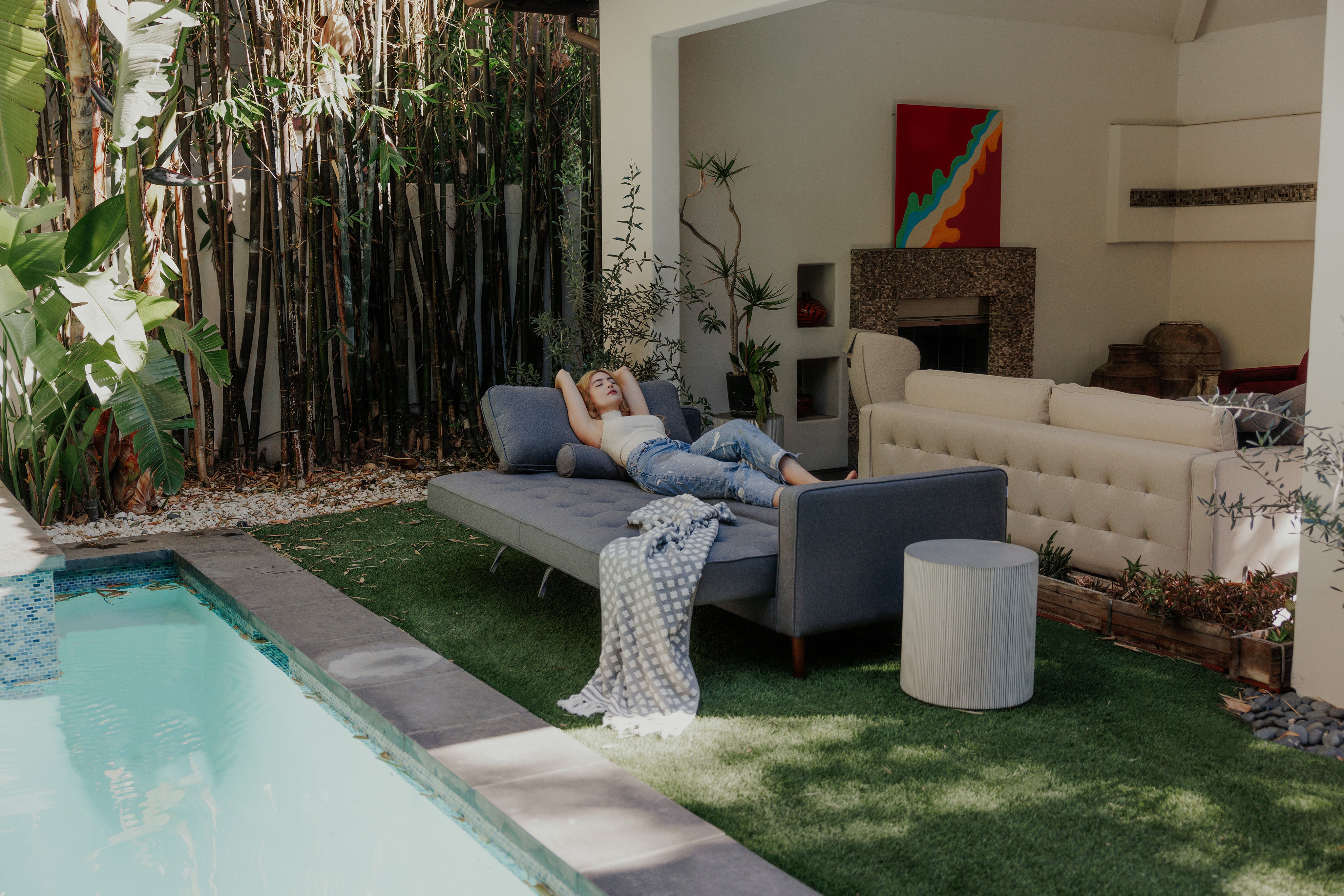 Girl is laying down on the sofabed
