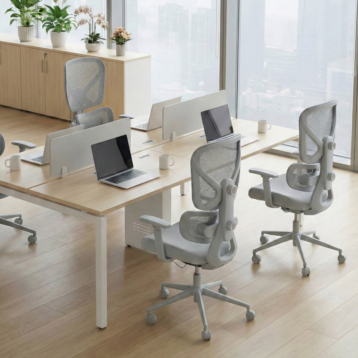 NH0-0023GR,Modern office setup with desks, chairs, and laptops in a bright room.
