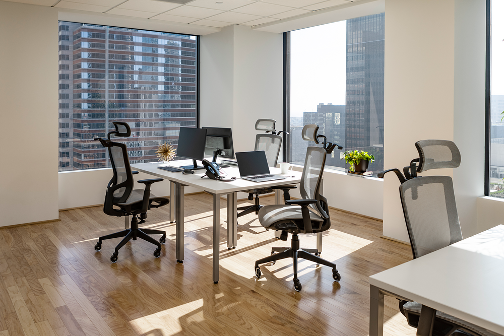 An office table with black ergonomic chairs.