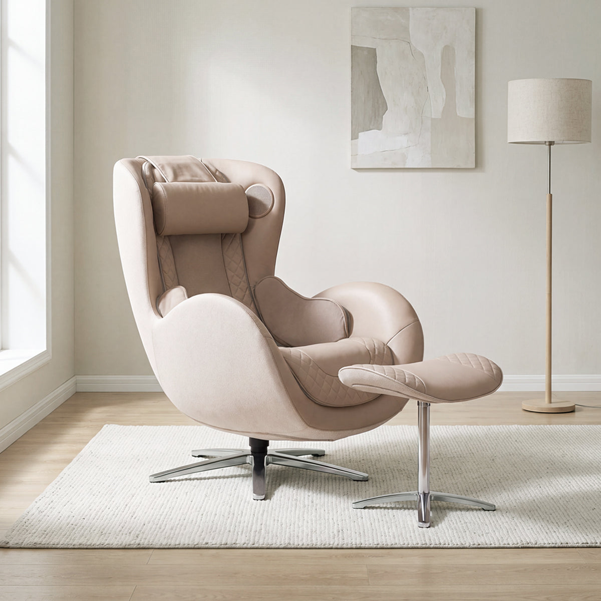 N-0003MS-V2, Mellow Sand ergonomic massage armchair with matching ottoman in a serene, contemporary American home during a bright daylight saving time afternoon. The chic blush-beige leather and fabric lounger rests on a light-colored woven area rug over light hardwood floors. In the background, warm, natural daylight streams from a large window on the left, illuminating a minimalist space adorned with a stylish floor lamp and a piece of abstract wall art.