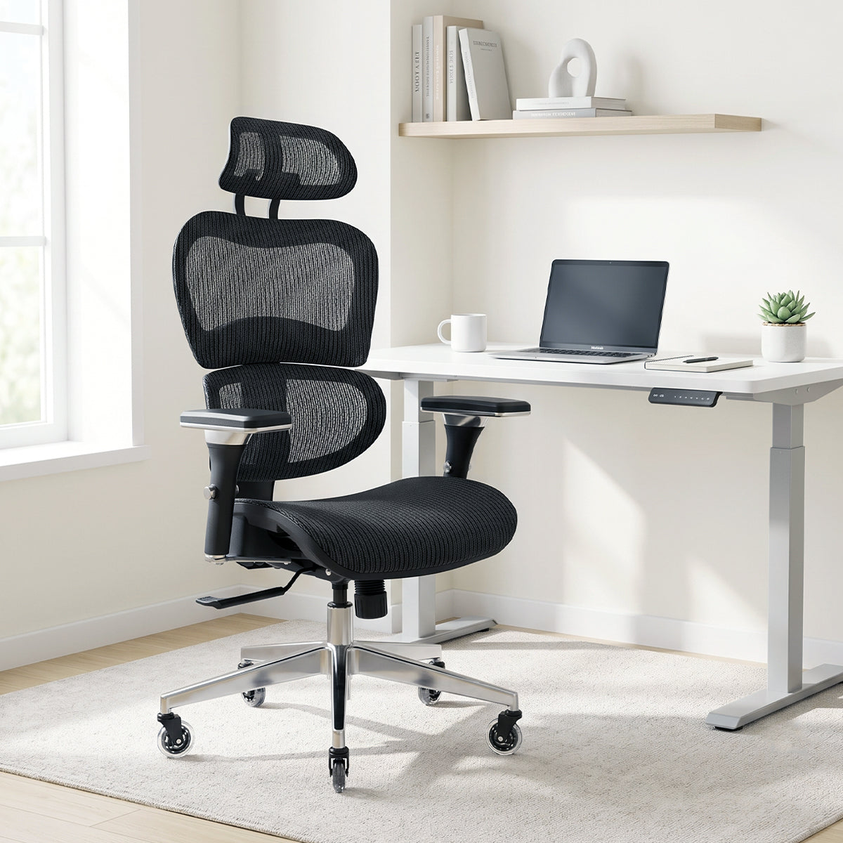 NHO-0001BL-V2, Black Coffee ergonomic mesh office chair in a bright, modern home office during a sunny afternoon. The high-back black chair features an adjustable headrest, lumbar support, and a polished silver base with casters, resting on a cream rug. In the background, natural sunlight illuminates a minimalist white standing desk with a laptop and a floating shelf with books.