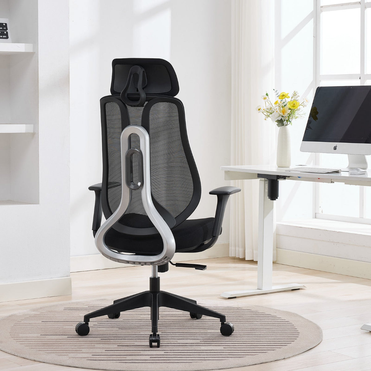 NHO-0025BL,Black office chair with headrest in a modern office setting