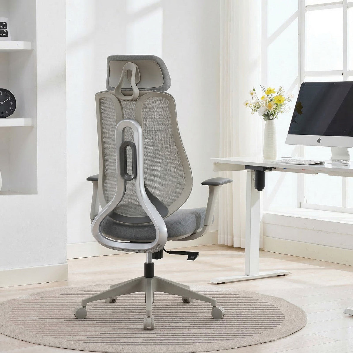 NHO-0025GR,Gray office chair in a bright room with a desk and computer monitor.