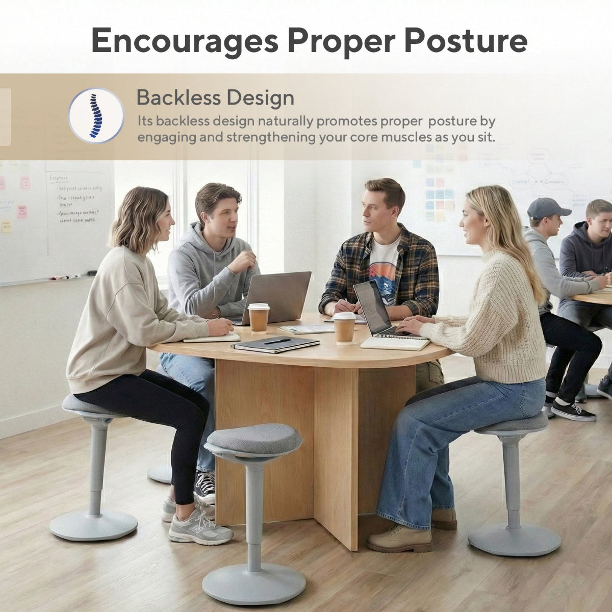 NH0-0019GR, group of people using gray backless wobble stools around a conference table, highlighting the design that encourages proper posture by engaging core muscles.