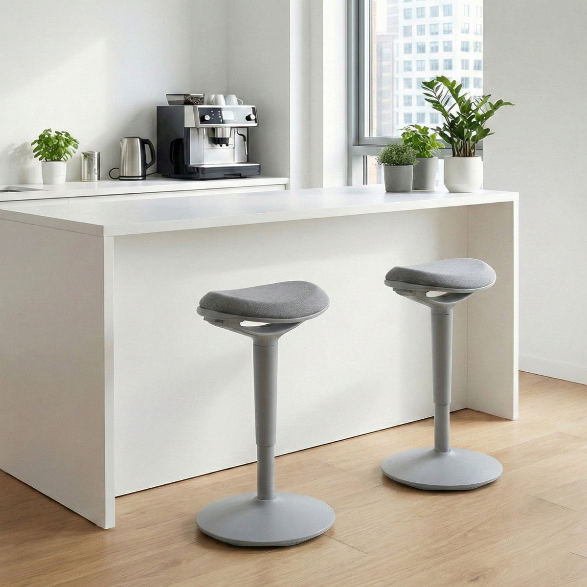 NH0-0019GR, modern compact kitchen bar area with a white counter, two gray adjustable-height stools, potted plants, and a coffee station, featuring a window with city views