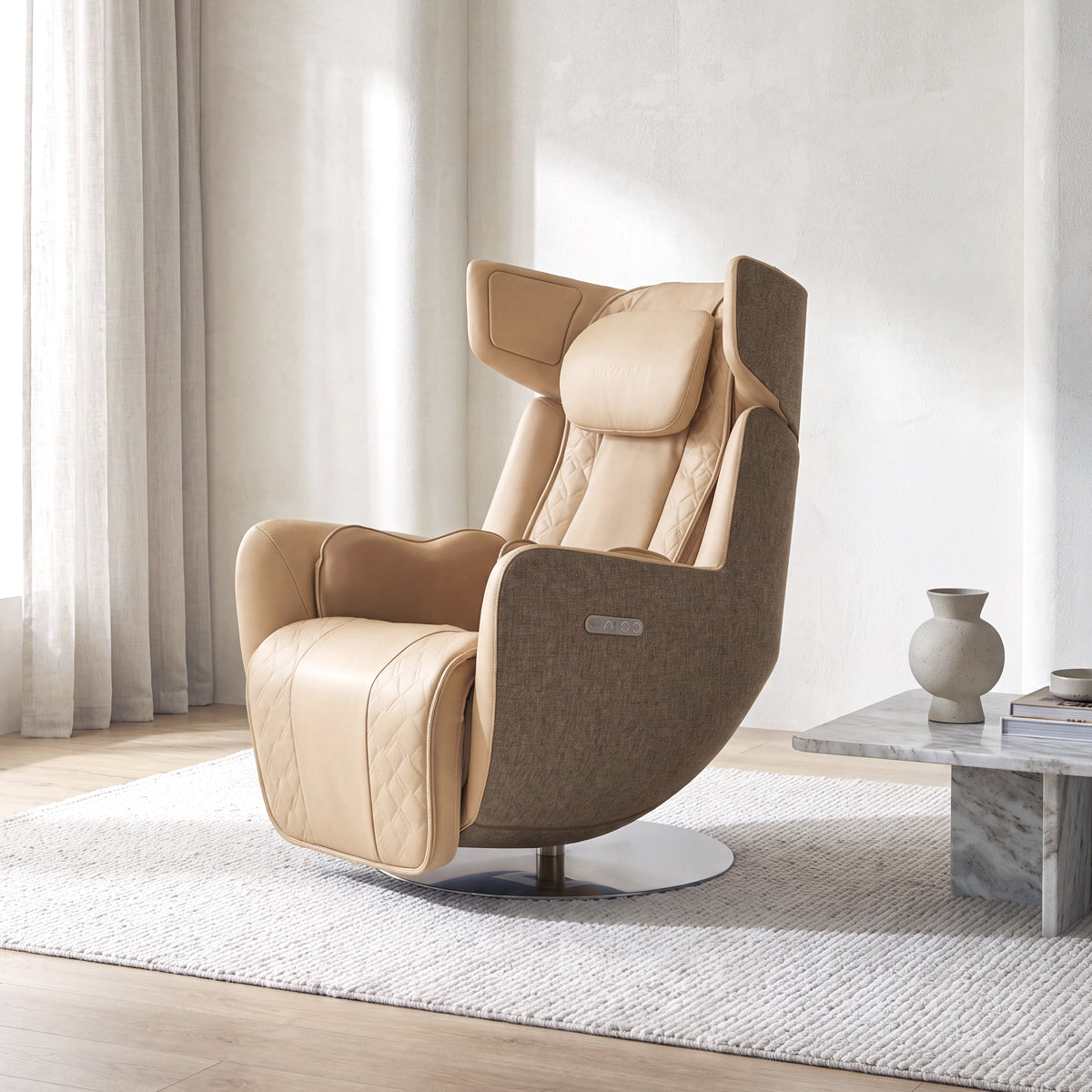 N-0005SD-V2, Mellow Sand ergonomic massage armchair in a bright, modern American living room during a sunny daylight saving time afternoon. The elegant beige leather and tan fabric lounger rests on a white textured rug over light hardwood floors, featuring a circular metallic pedestal base. In the background, warm natural sunlight streams through a window with sheer curtains, illuminating a minimalist marble side table with a ceramic vase.