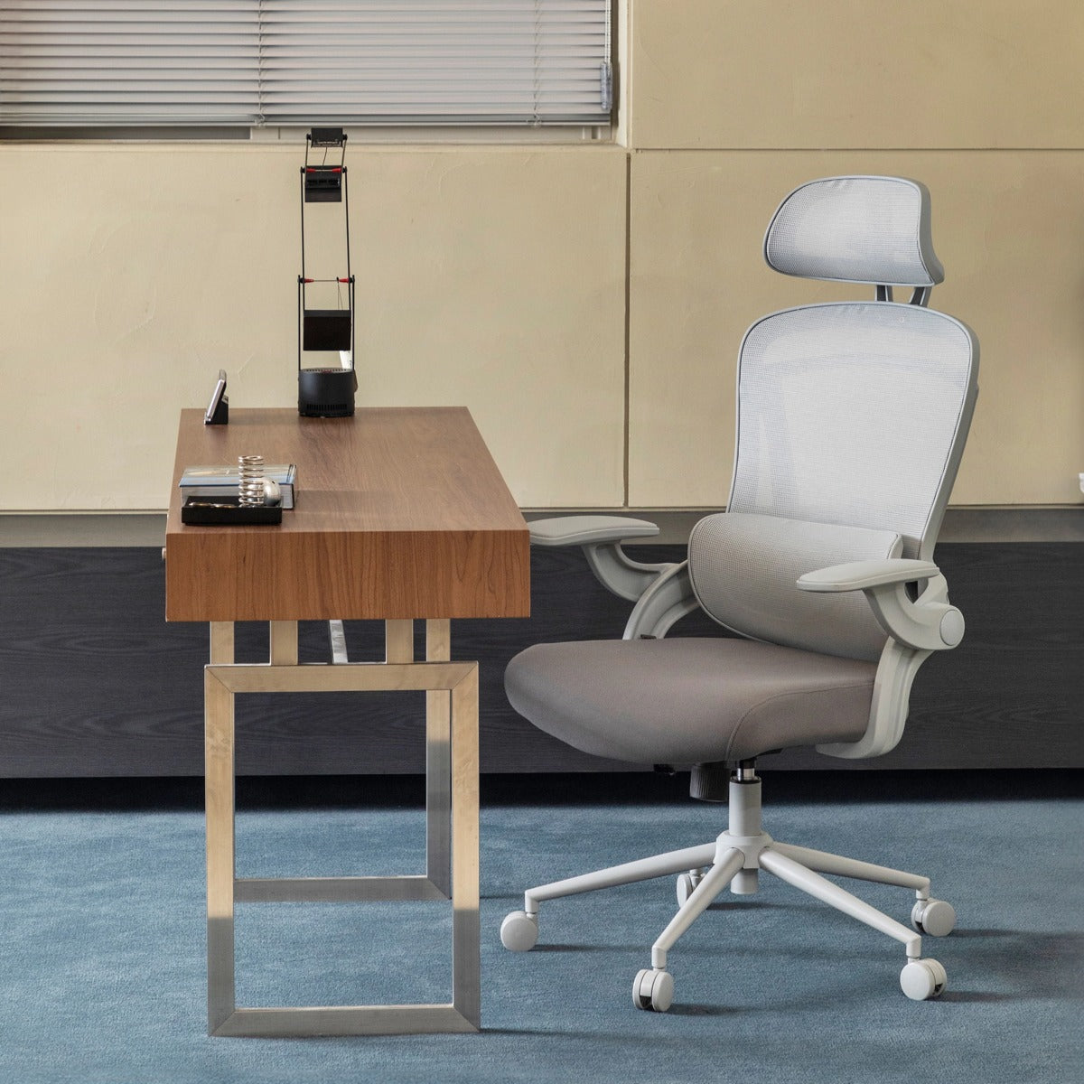 NHO-0013GR,Gray office chair next to a wooden desk in an office setting